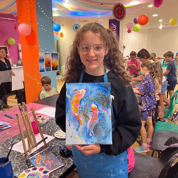 A child with a painting of fish