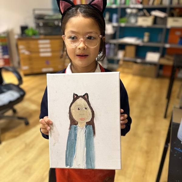 A child with a portrait drawing
