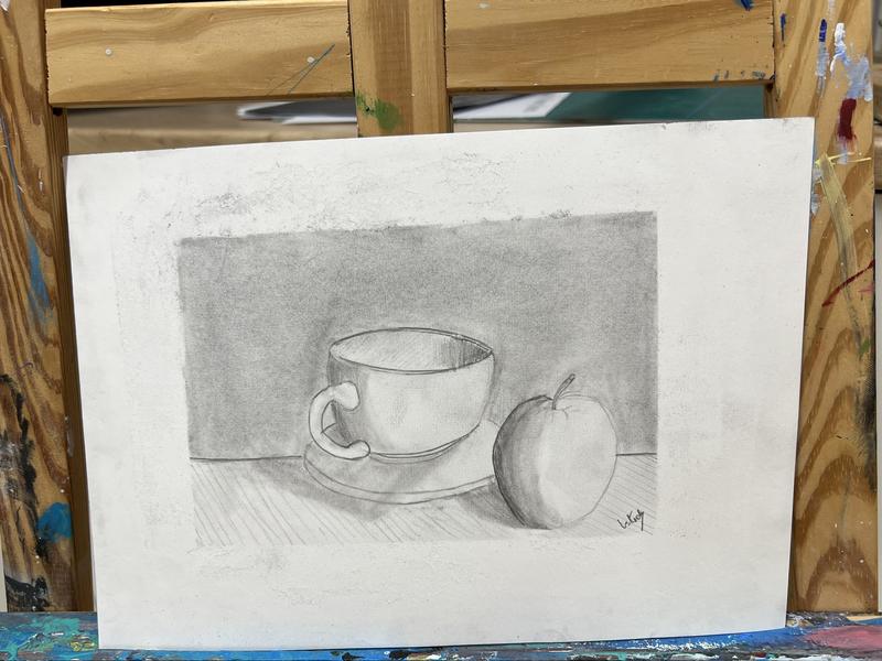 Teen pencil still life of a cup and apple on an easel
