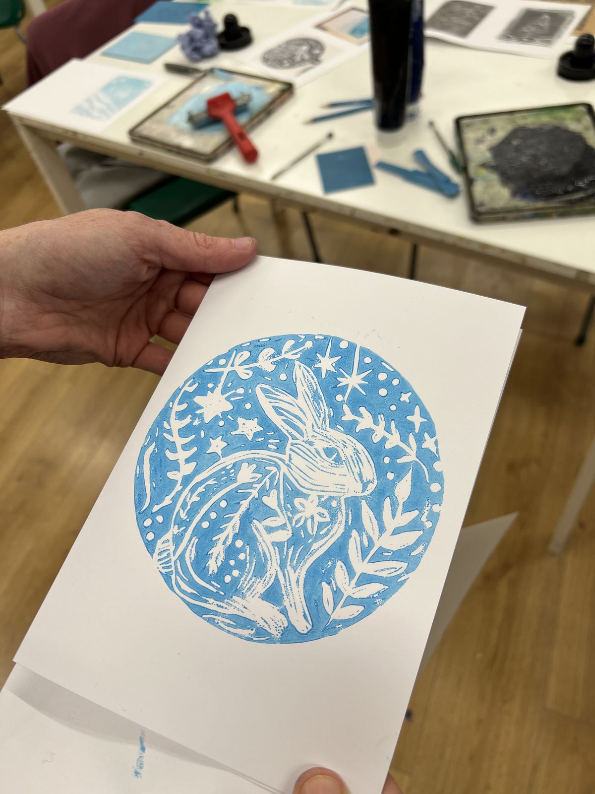 Hand-printed lino print of a hare in blue ink